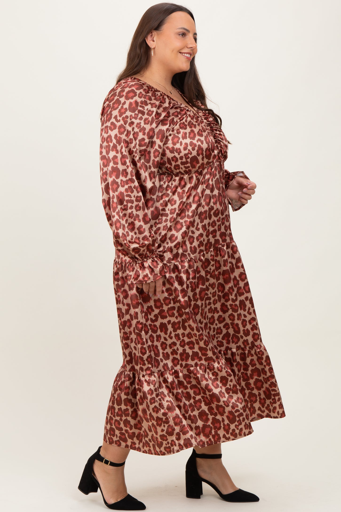 woman wearing a brown leopard print long sleeve plus size dress with ruffle hem and black high heels