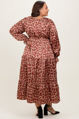 woman wearing a plus size brown leopard print maxi dress with long sleeves and a tiered skirt, facing away from the camera