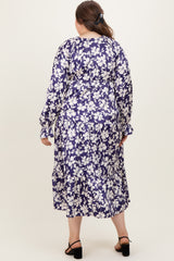 woman wearing a floral print long sleeve maternity plus dress with a tiered skirt, showing the back view