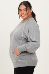 woman wearing a gray plus size sweatshirt with ribbed detailing and side pockets