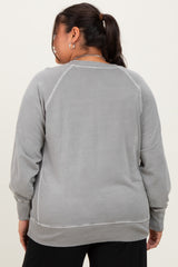 woman wearing a light grey plus size sweatshirt with ribbed cuffs and hem, viewed from the back