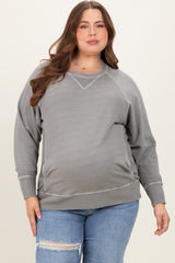 woman wearing a gray oversized maternity sweatshirt with side ruching and a baby bump visible