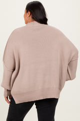 woman wearing a beige oversized sweater with a slouchy fit and dropped shoulder seams