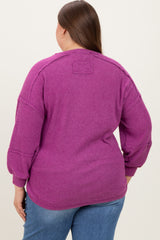 woman wearing a purple ribbed maternity plus top, showing the back with a relaxed fit and slightly puffed sleeves