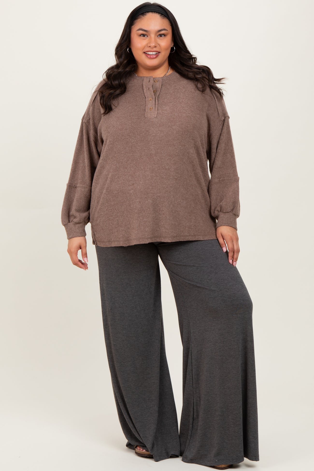 woman wearing a brown long sleeve henley top and gray wide-leg lounge pants