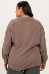 woman wearing a brown oversized ribbed sweater with a relaxed fit and drop shoulders, view from the back