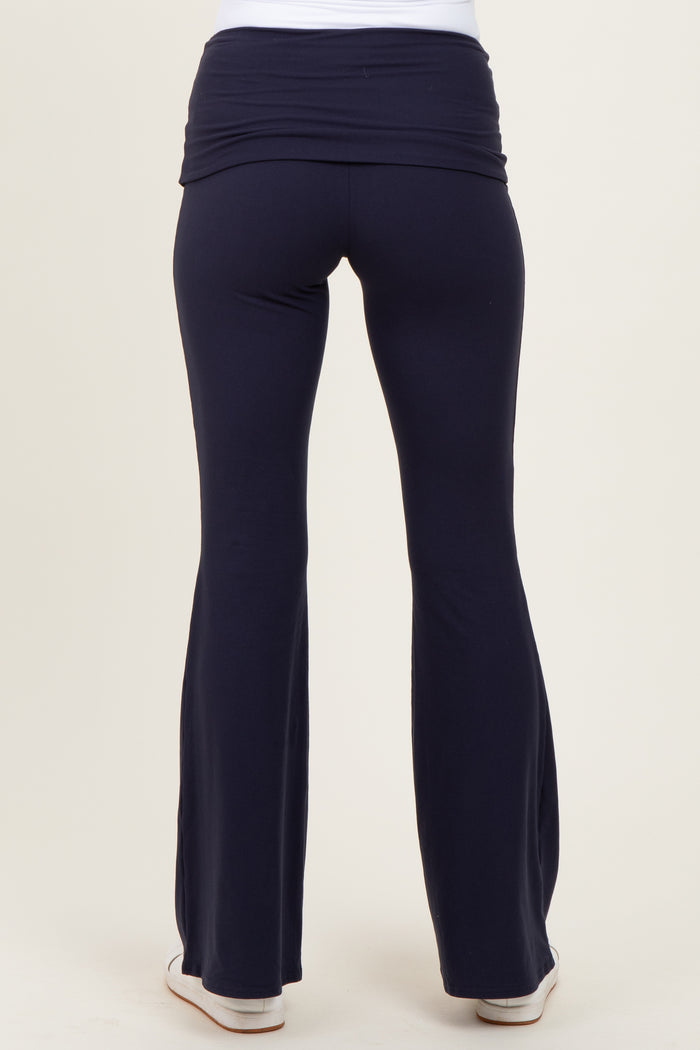woman wearing navy blue maternity yoga pants with a flattering wide waistband, shown from the back