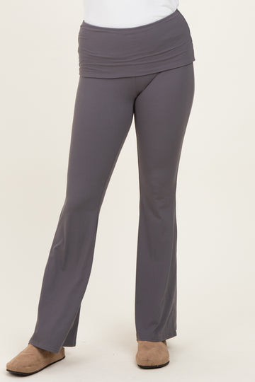 woman wearing gray fold-over waistband flared pants with a fitted style and paired with casual footwear