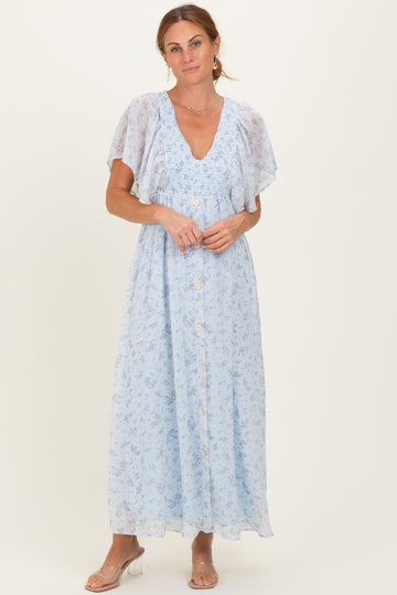 woman wearing a light blue floral maxi dress with flutter sleeves and a button-down front