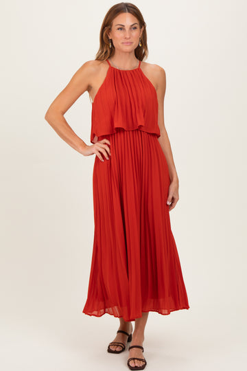 woman wearing a red pleated maxi dress with a halter neckline and layered ruffle details