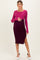 woman wearing a maternity ribbed dress in pink and purple with a side slit, holding her baby bump