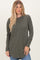 woman wearing an olive green long sleeve ribbed top with a round neckline and curved hemline