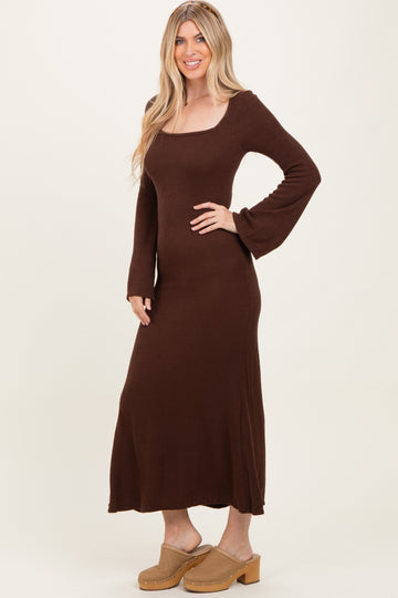 woman wearing a brown long sleeve ribbed maxi dress and beige platform clogs