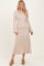 woman wearing a beige long sleeve ribbed maxi dress with a square neckline and flared sleeves