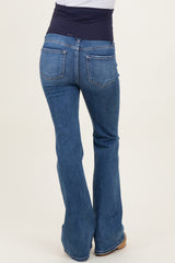 woman wearing a pair of blue bootcut maternity jeans with a stretchy navy waistband viewed from the back
