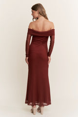 woman wearing a burgundy off-the-shoulder maxi dress with long sleeves, showing a fitted silhouette from the back