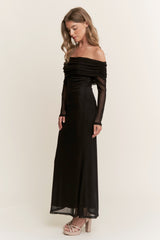 woman wearing a black off-shoulder long evening dress with sheer long sleeves and a fitted silhouette