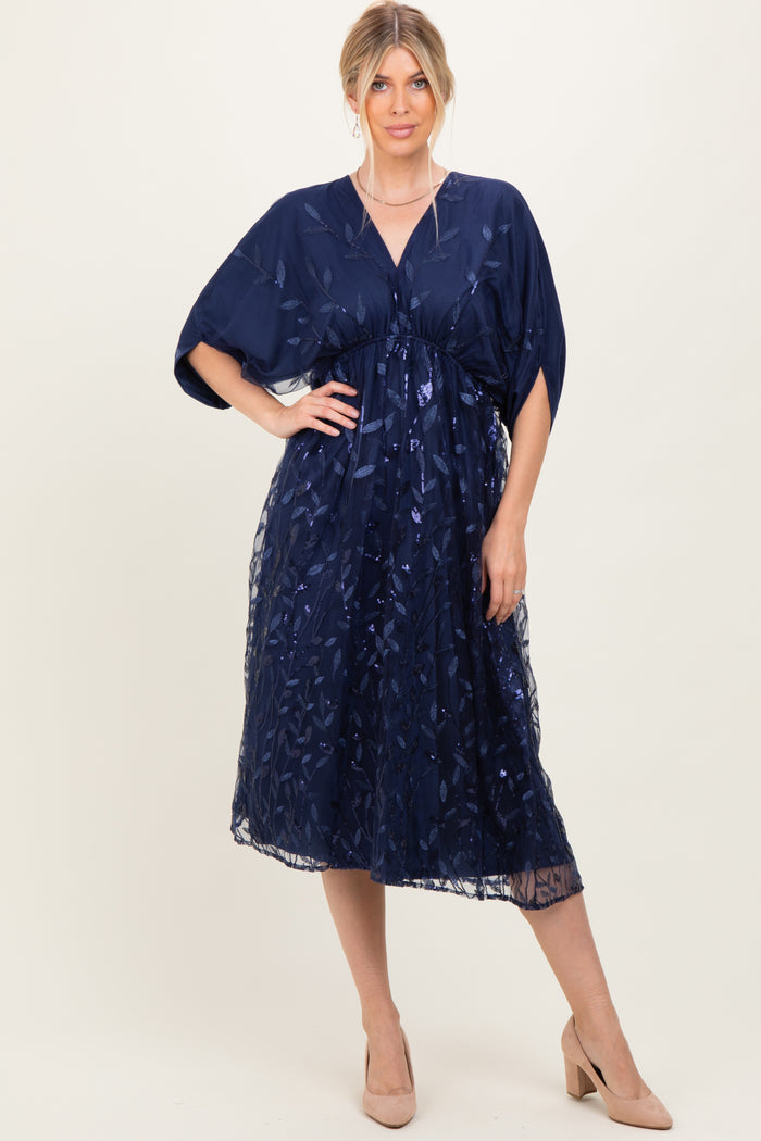 woman wearing a navy blue floral lace midi dress with a v-neck and short sleeves