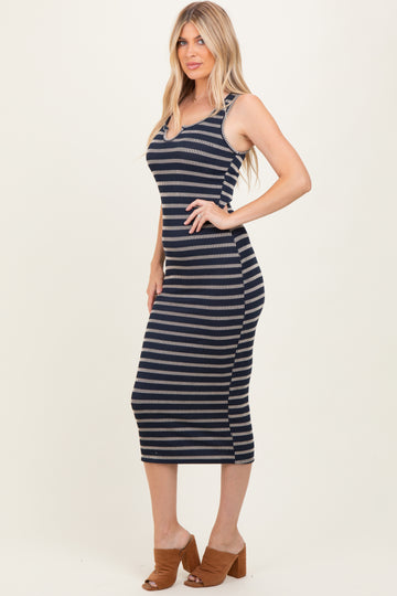 woman wearing a navy and cream striped midi dress with a fitted silhouette and spaghetti straps