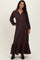 woman wearing a dark brown maternity maxi dress with a collar, button details, and a ruffled hem, showcasing her baby bump