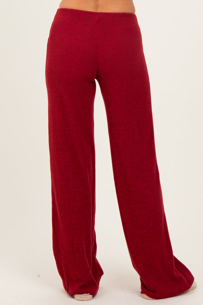 woman wearing burgundy wide-leg knitted pants shown from the back