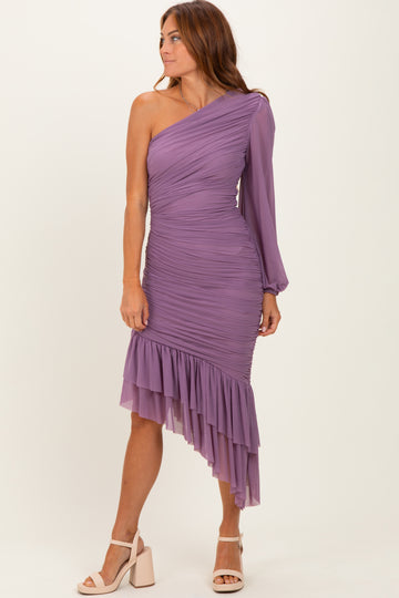 woman wearing a lavender one-shoulder ruched dress with a ruffled hem and long sleeve detail
