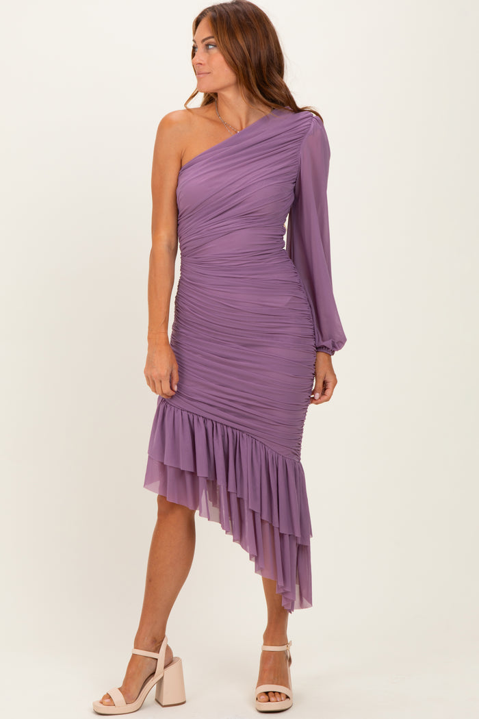 woman wearing a lavender one-shoulder ruched dress with a ruffled hem and long sleeve detail