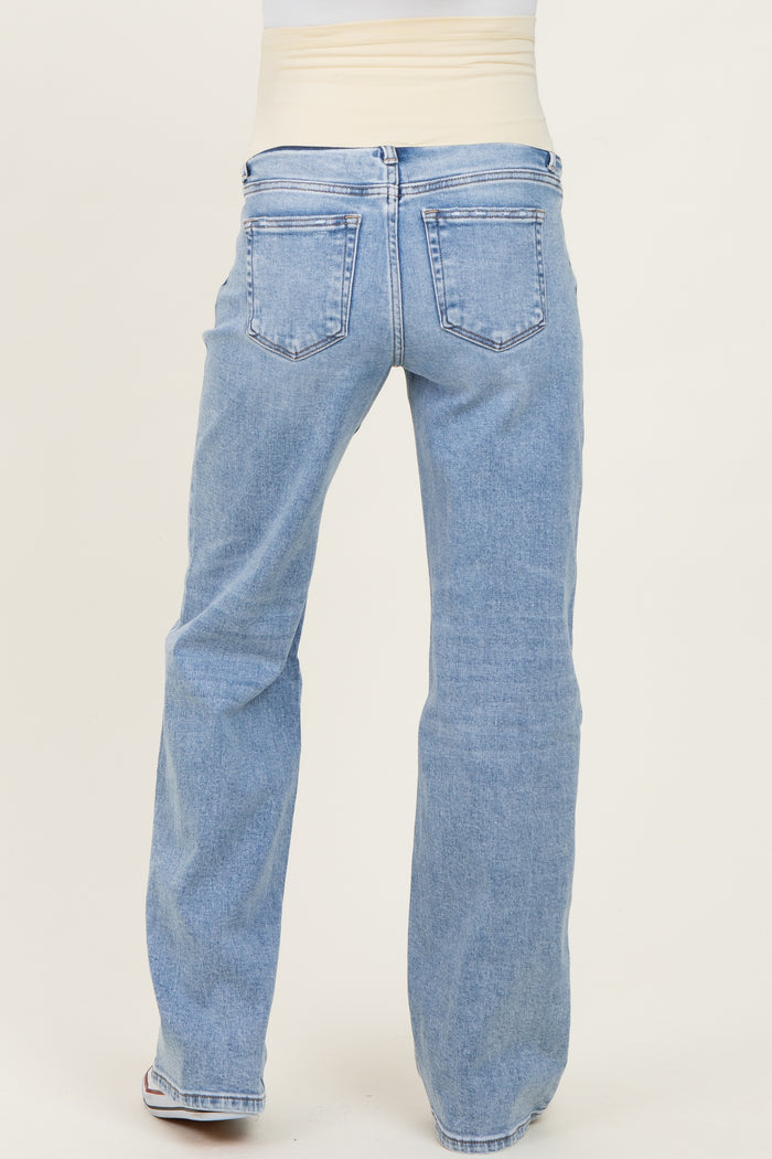 woman wearing light blue maternity jeans with a stretchy waistband, viewed from the back