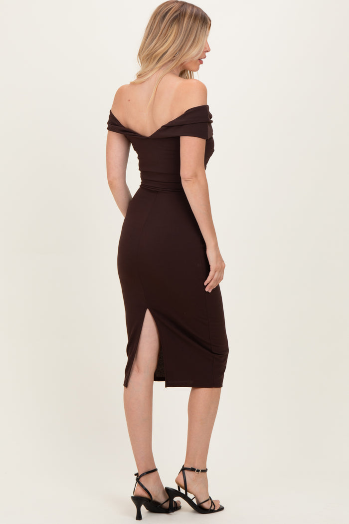 woman wearing a burgundy off-the-shoulder midi dress with a slit and strappy black heels, viewed from the back