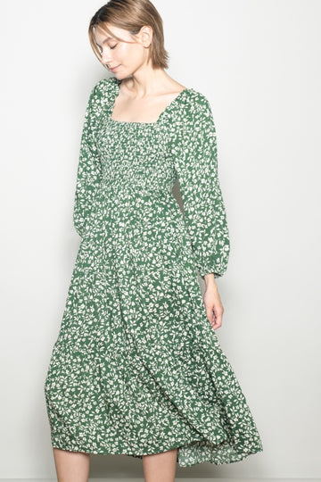 woman wearing a green floral long sleeve midi dress with a square neckline and relaxed fit