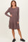 woman wearing a dusty rose long sleeve striped dress with a tiered skirt and a round neckline