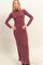 woman wearing a burgundy long sleeve fitted maxi dress with a high neck