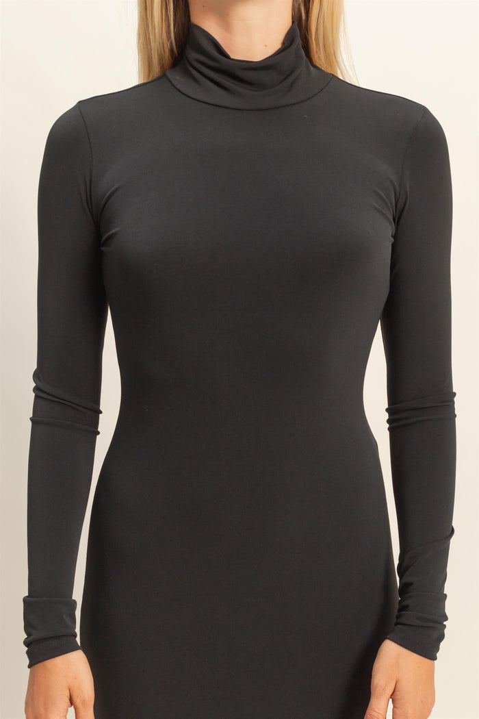 woman wearing a fitted black turtleneck long sleeve dress with a sleek silhouette
