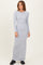 woman wearing a light gray ribbed maxi dress with long sleeves and a relaxed fit