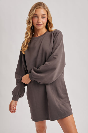 woman wearing a charcoal gray long sleeve oversized sweatshirt dress with balloon sleeves