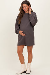 woman wearing a charcoal gray maternity sweatshirt dress with long sleeves and a visible baby bump