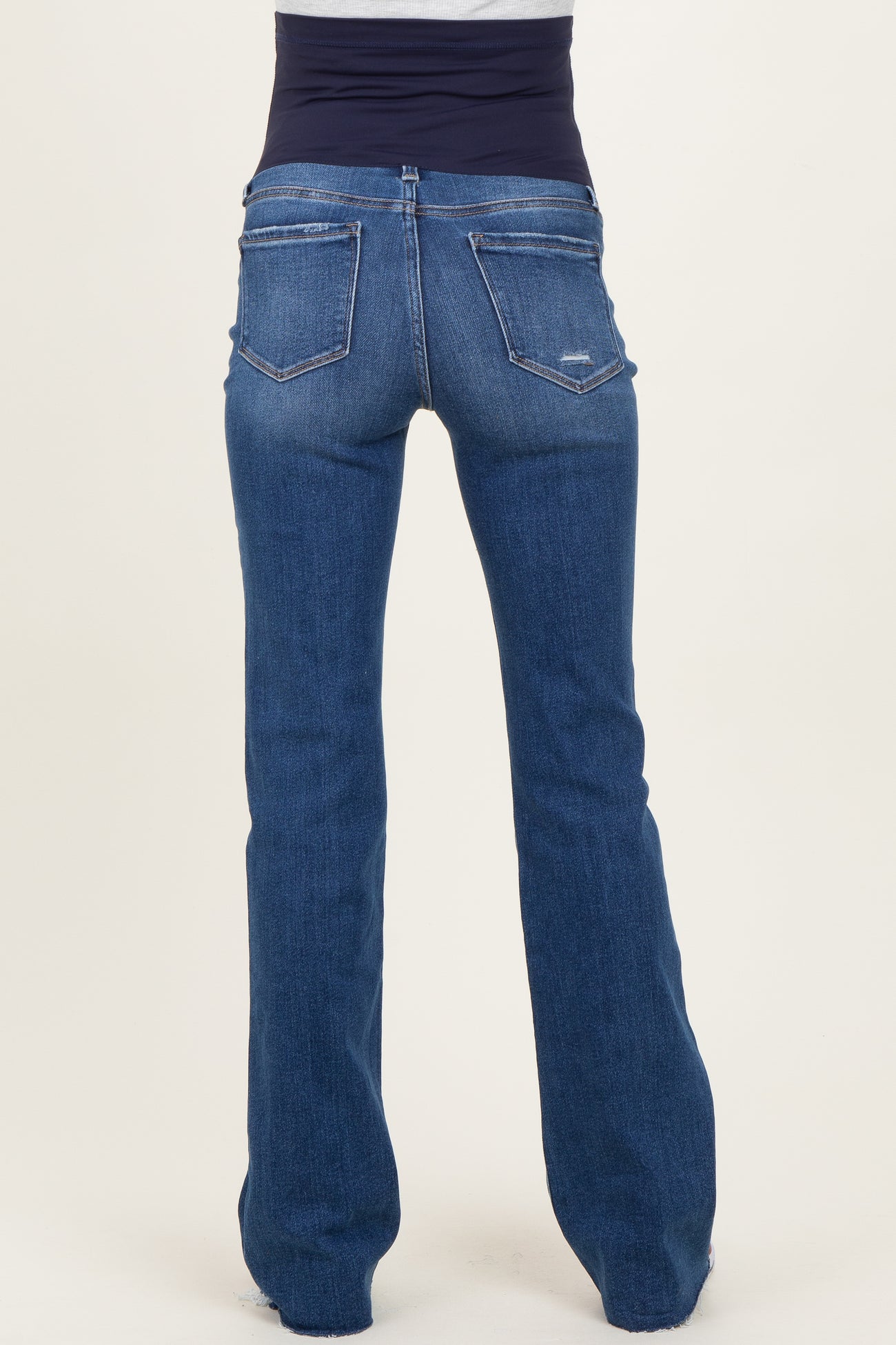 maternity wear blue flared jeans with a smooth navy waistband, viewed from the back