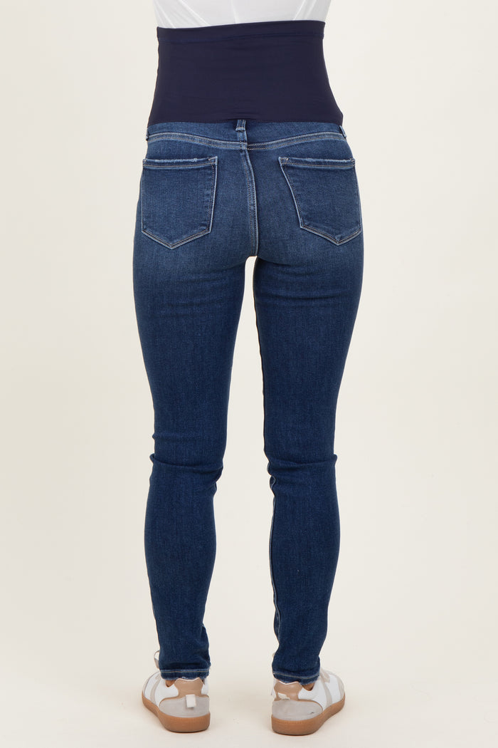 woman wearing dark blue maternity jeans with a supportive belly band, viewed from the back