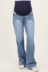 woman wearing light blue maternity flared jeans with a navy waistband