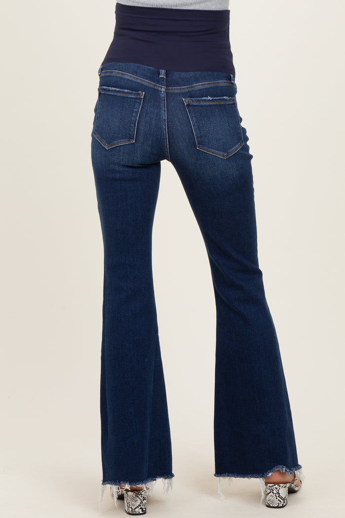 woman wearing dark blue maternity flare jeans with a stretchy navy waistband and back pockets