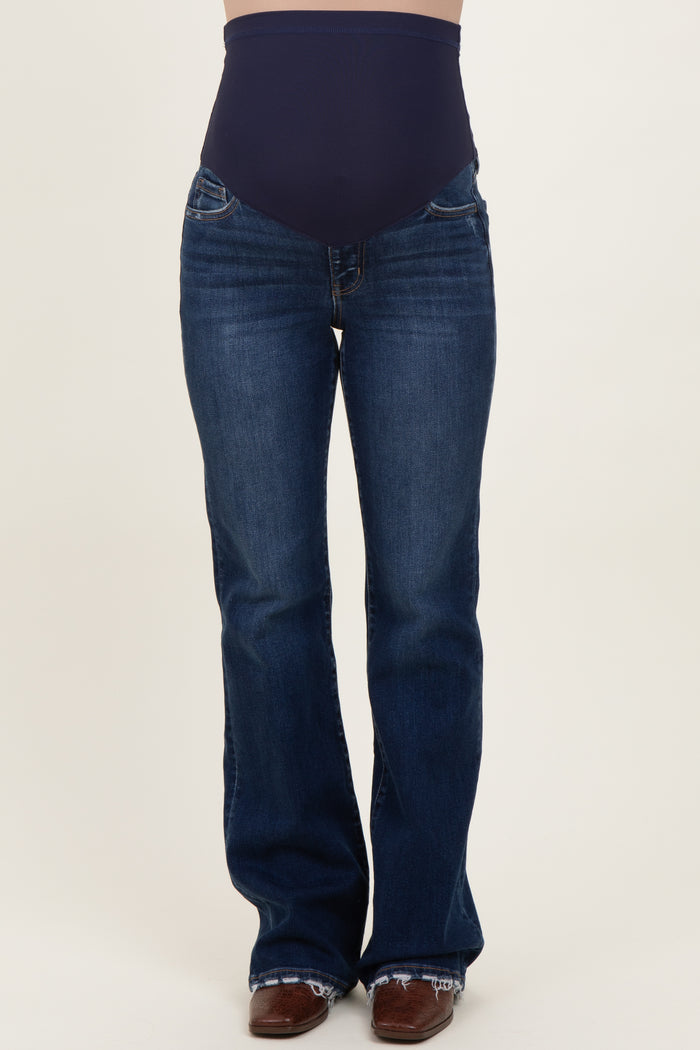 woman wearing dark blue maternity flare jeans with a high waistband