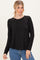 woman wearing a black long sleeve top and blue jeans