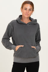 woman wearing a gray hooded sweatshirt with a front pocket and relaxed fit