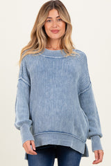 woman wearing a light blue striped maternity sweater with a relaxed fit and side slits