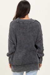 woman wearing a dark gray oversized ribbed sweater with long sleeves and a relaxed fit, viewed from the back