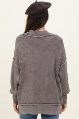 woman wearing a cozy gray striped oversized sweater with a high collar and relaxed fit, viewed from the back