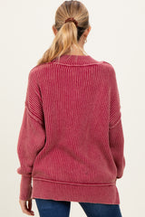 woman wearing a burgundy striped oversized maternity sweater viewed from the back
