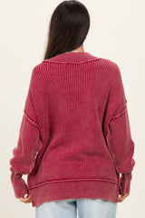 woman wearing a ribbed oversized maroon sweater with a relaxed fit and dropped shoulder seams