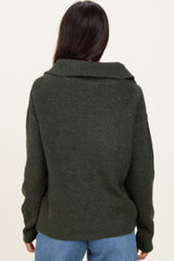 woman wearing an olive green oversized ribbed sweater with a wide collar, viewed from the back