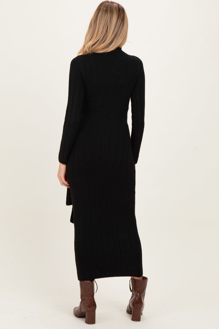 woman wearing a black ribbed maternity dress with long sleeves and a high slit at the back
